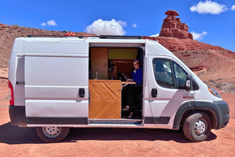 Tee Corley working her van life job remotely in her van while camped at Mexican Hat.