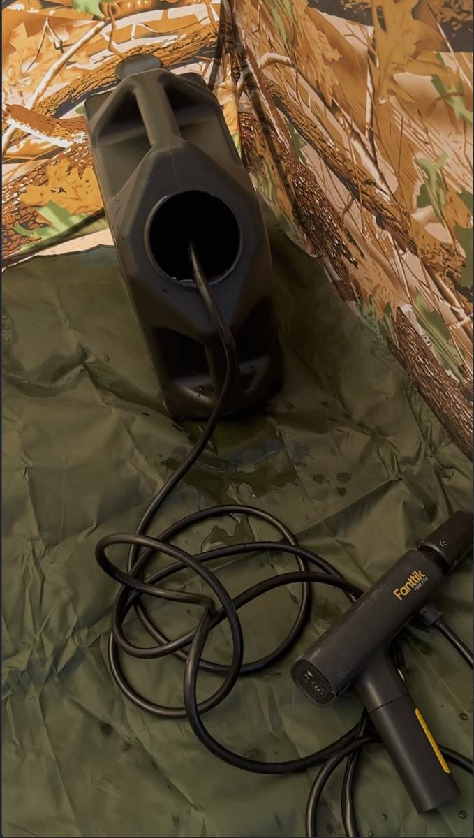 Inside the pop-up shower tent, set up and ready for a hot shower